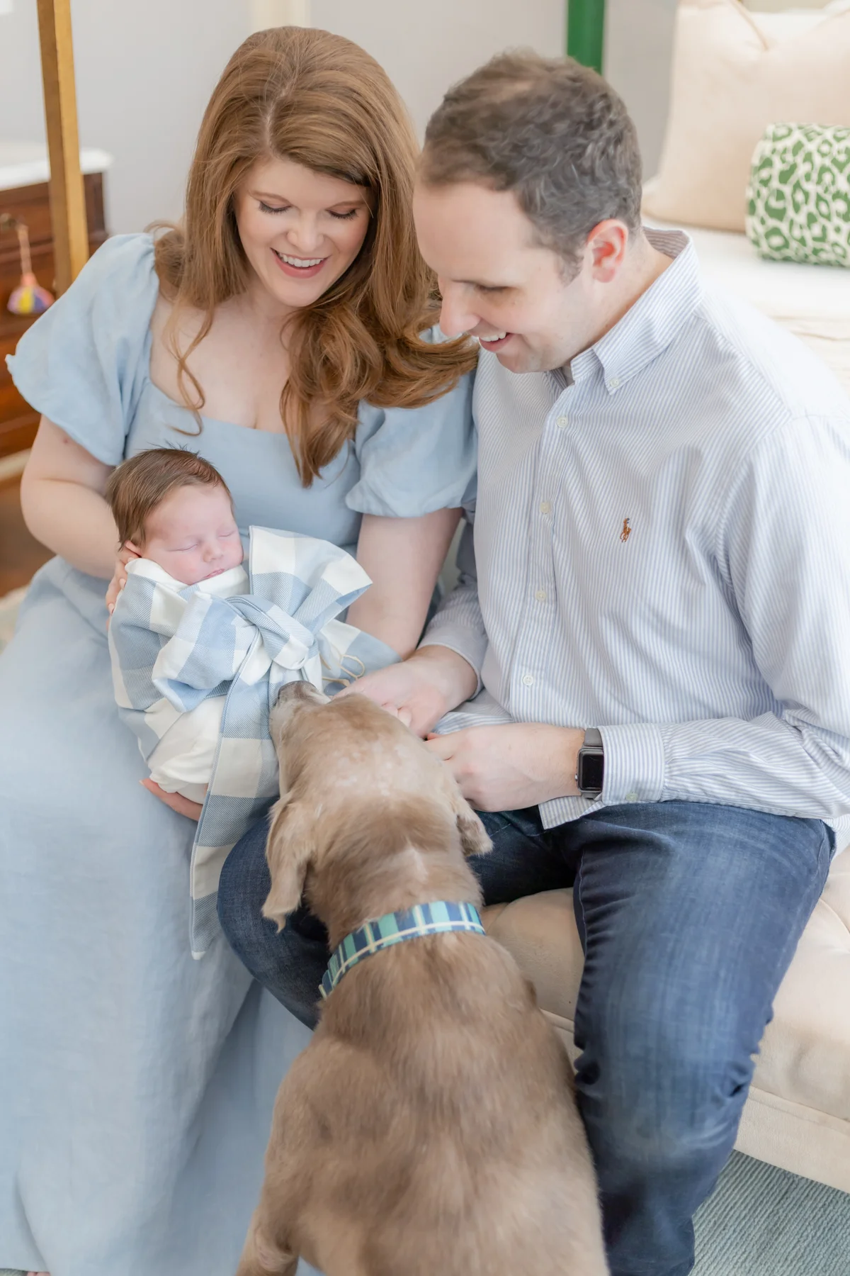 Dr. Smith and Emily at home with their baby and Labrador retriever